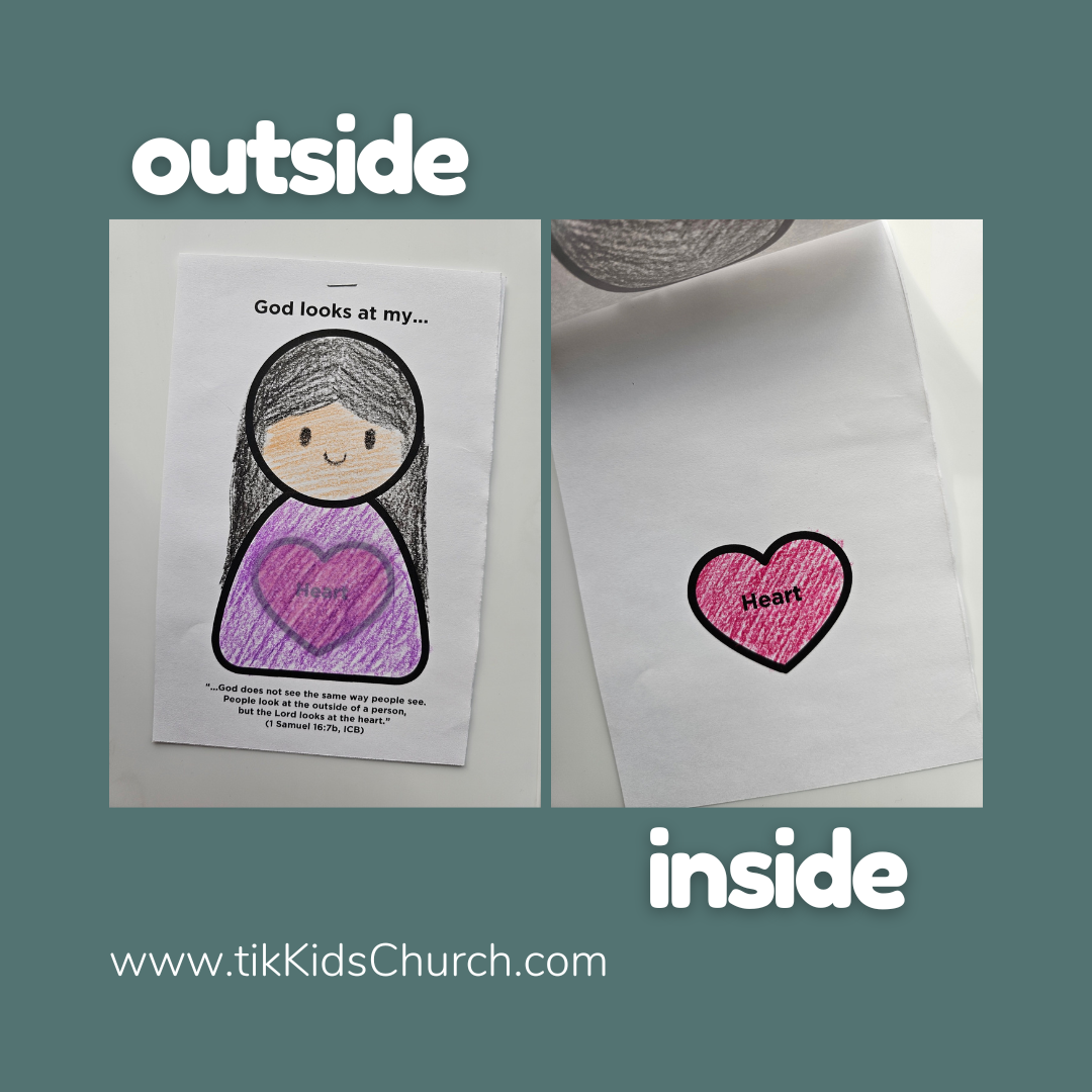 Children's craft project with a printed sheet and heart cutout on a blue background.